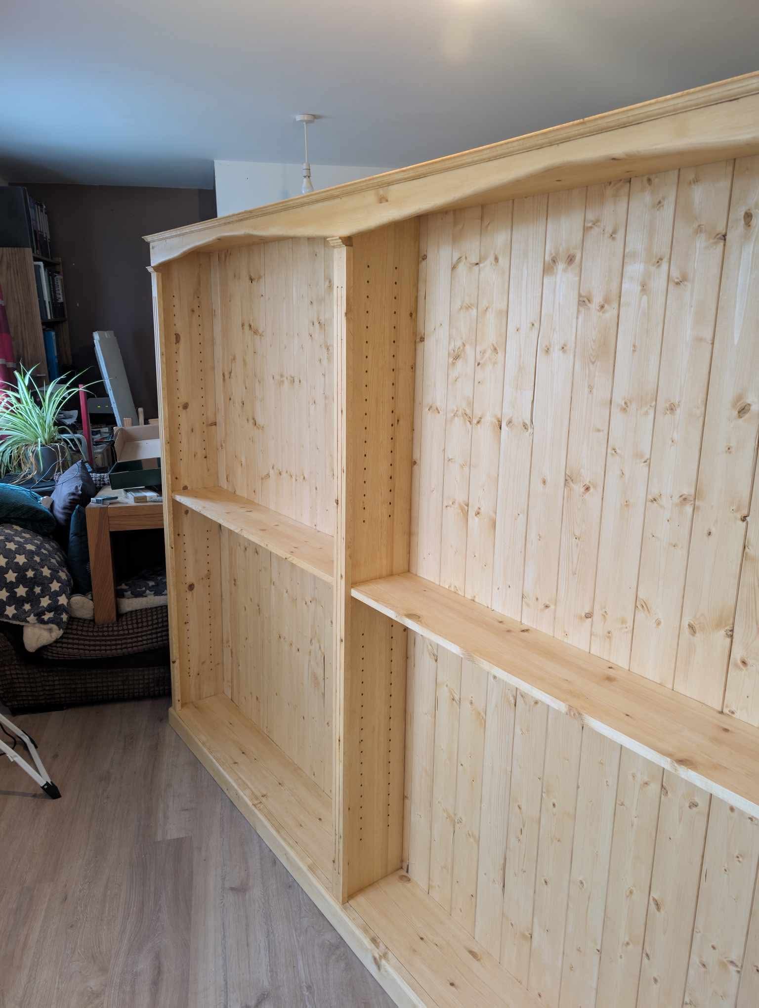 Side-on view of the bookcase showing the rows of shelf-pin holes drilled into the upright panels, allowing the shelves to be moved up and down.